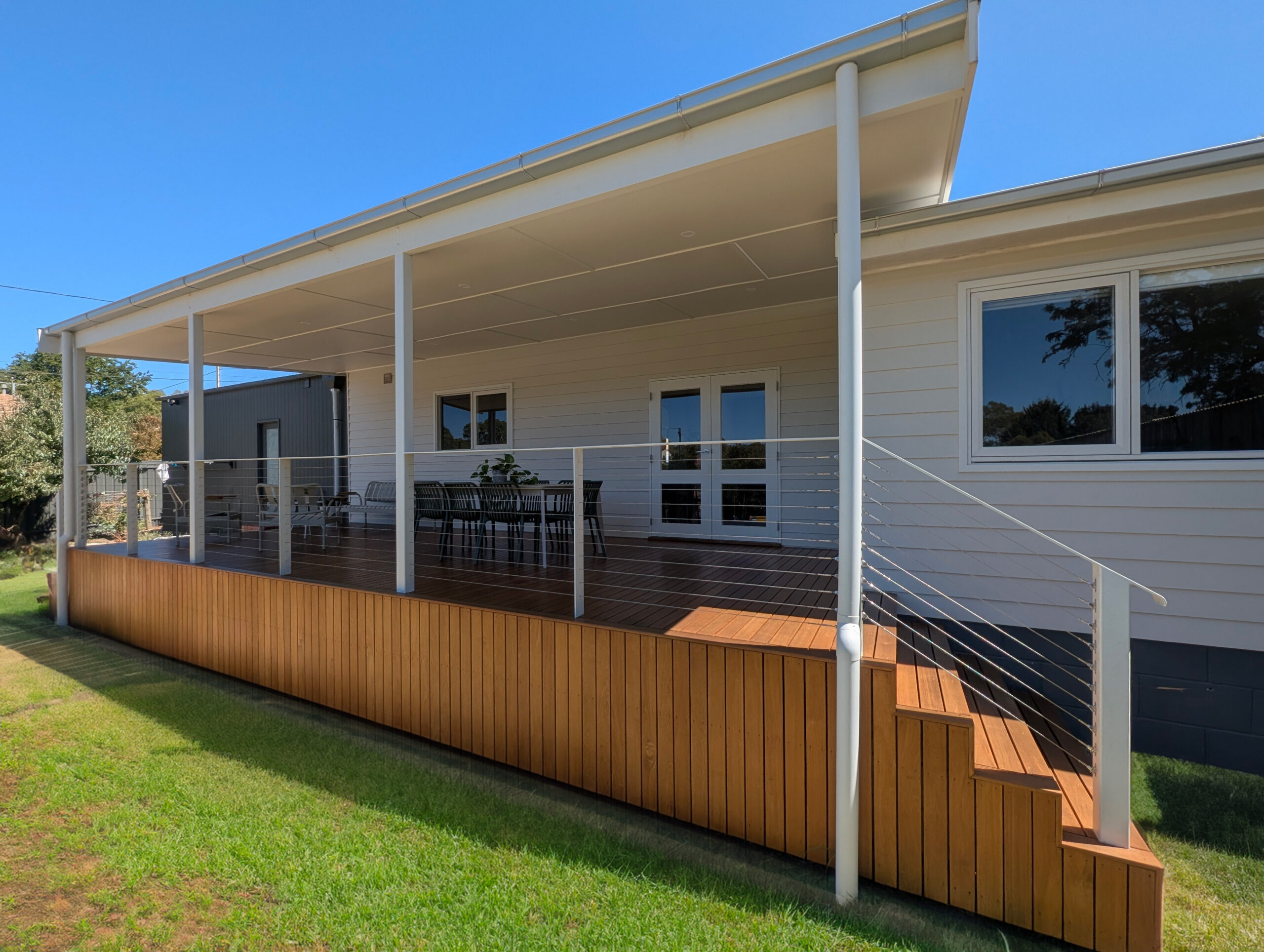 The Balhannah deck build from the lawn — new verandah roof with downlights over the full-length hardwood deck, slatted skirting, cable balustrade and corner steps