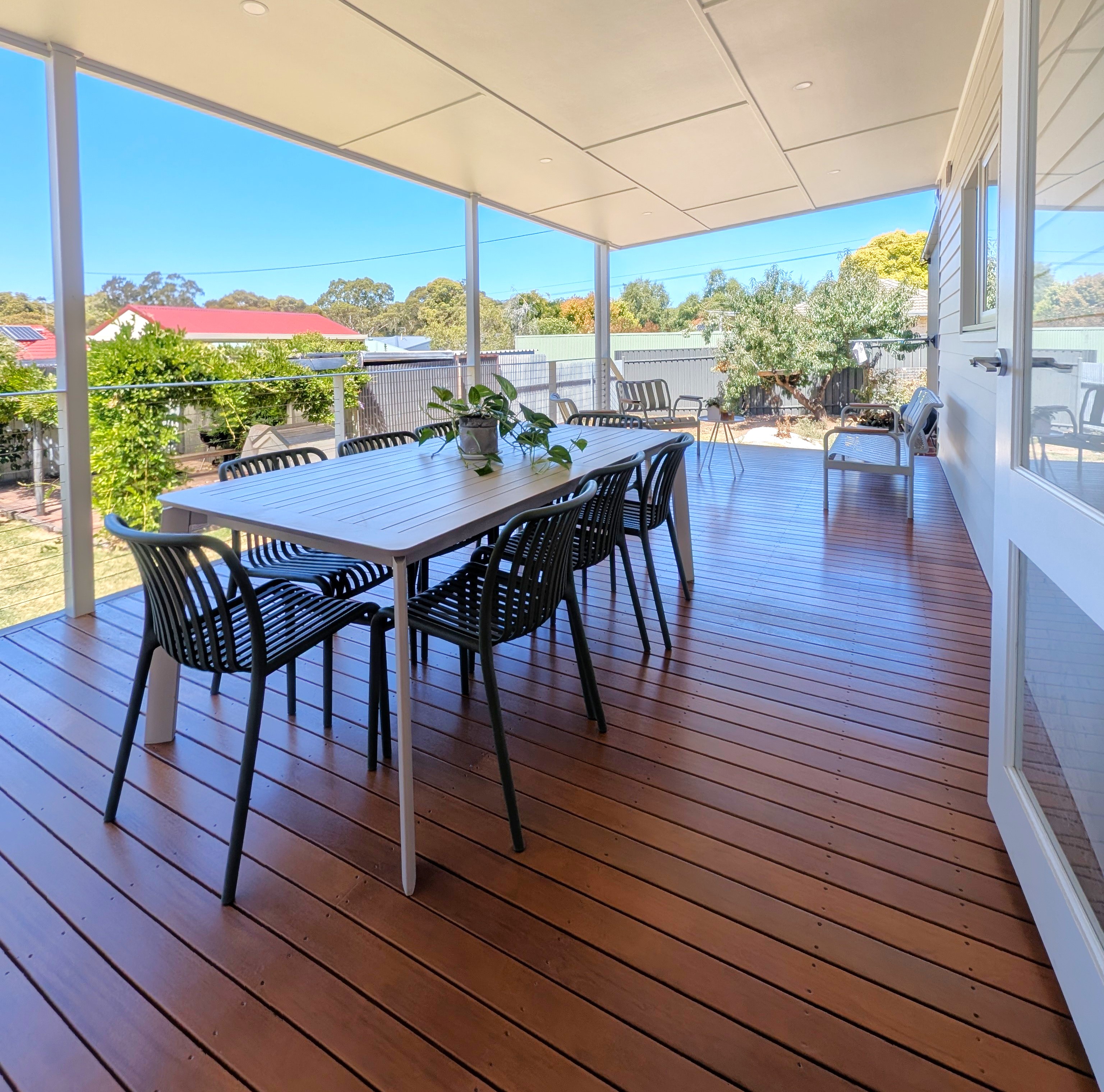 Outdoor dining under the new Balhannah verandah roof, downlights overhead and the backyard beyond