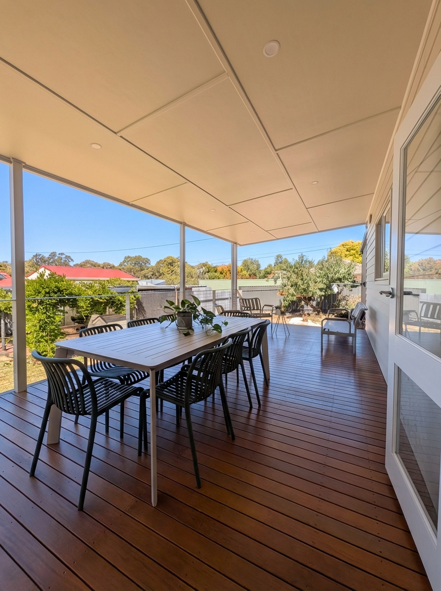 On the new Balhannah hardwood deck — outdoor dining for eight under the lined verandah roof, lounge corner at the far end
