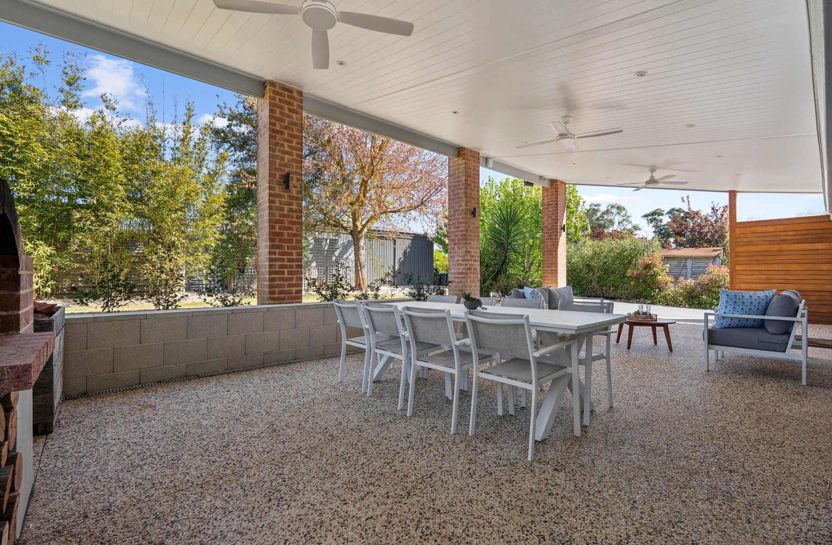 New alfresco built at Charleston — lined ceiling with fans over brick pillars, outdoor dining on exposed aggregate