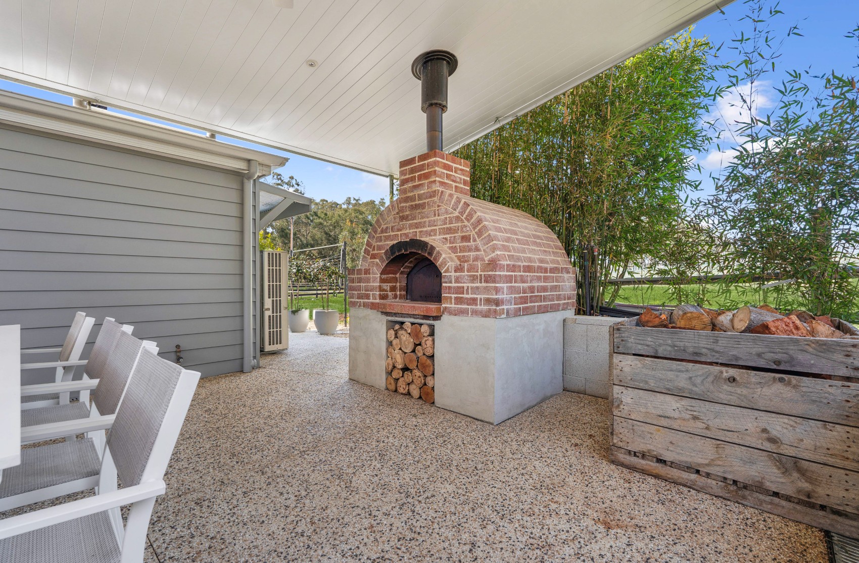 Brick wood-fired pizza oven with firewood storage, built into the new Charleston alfresco
