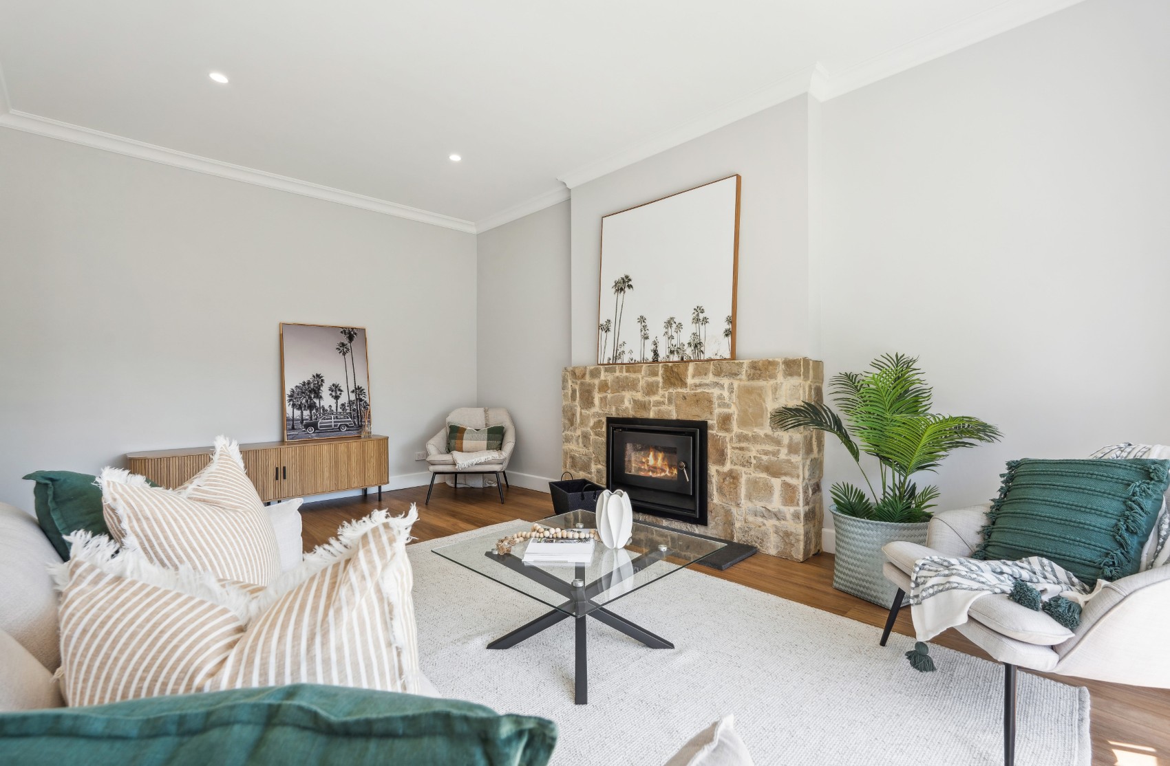 Charleston living room from the sofa — sandstone chimney breast and timber credenza