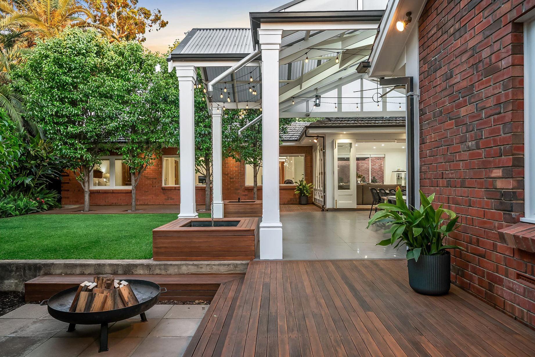 New Merbau decking under the Burnside pavilion posts at dusk, looking into the open living area