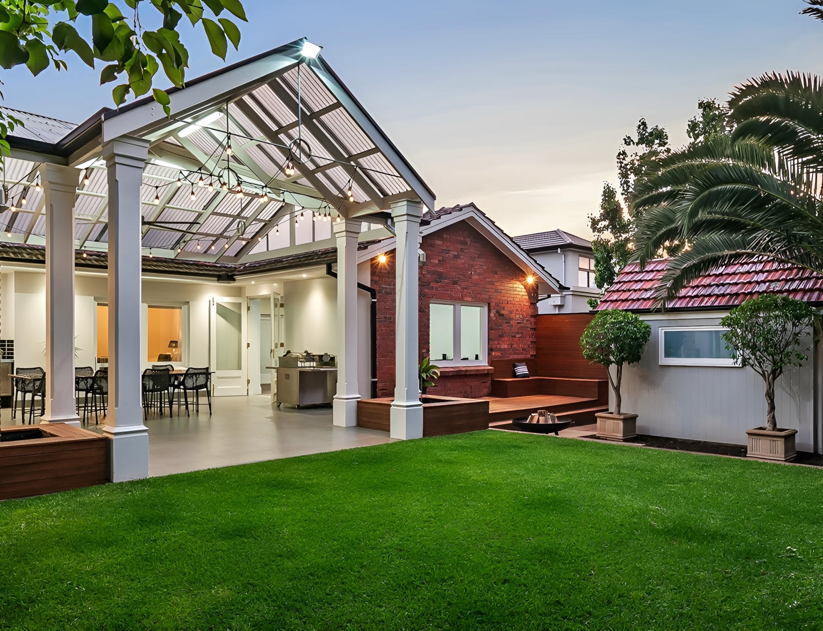 View of Burnside home backyard showing manicured lawn and pergola