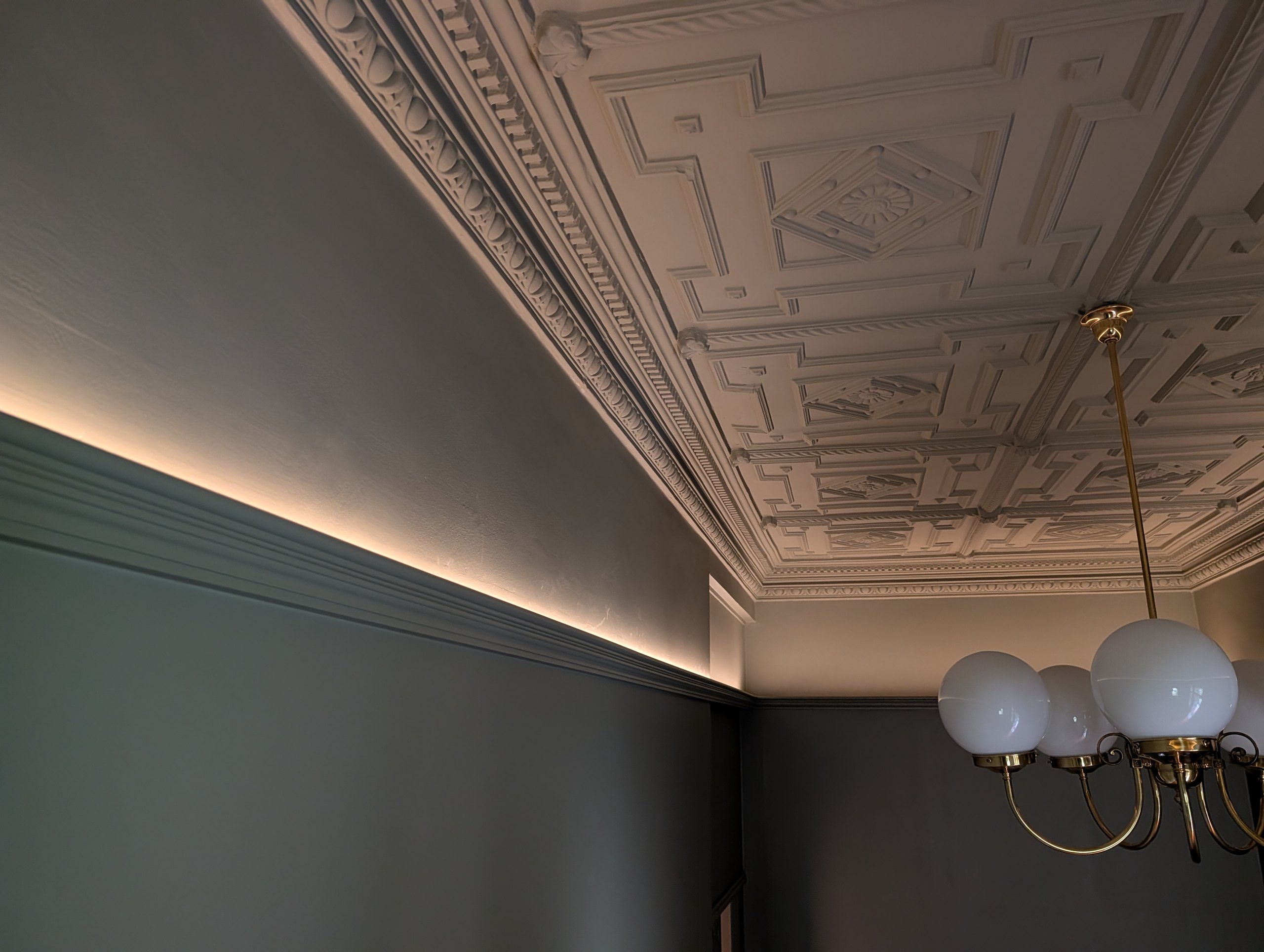 Ornate hall ceiling with concealed LED lighting running above the picture rail on both sides