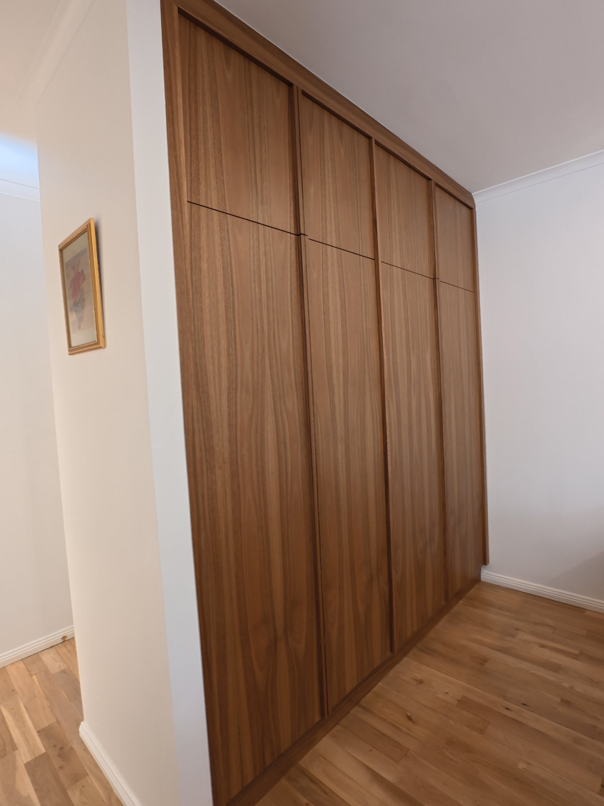 Close view of the timber laundry doors and their grain, along the hallway