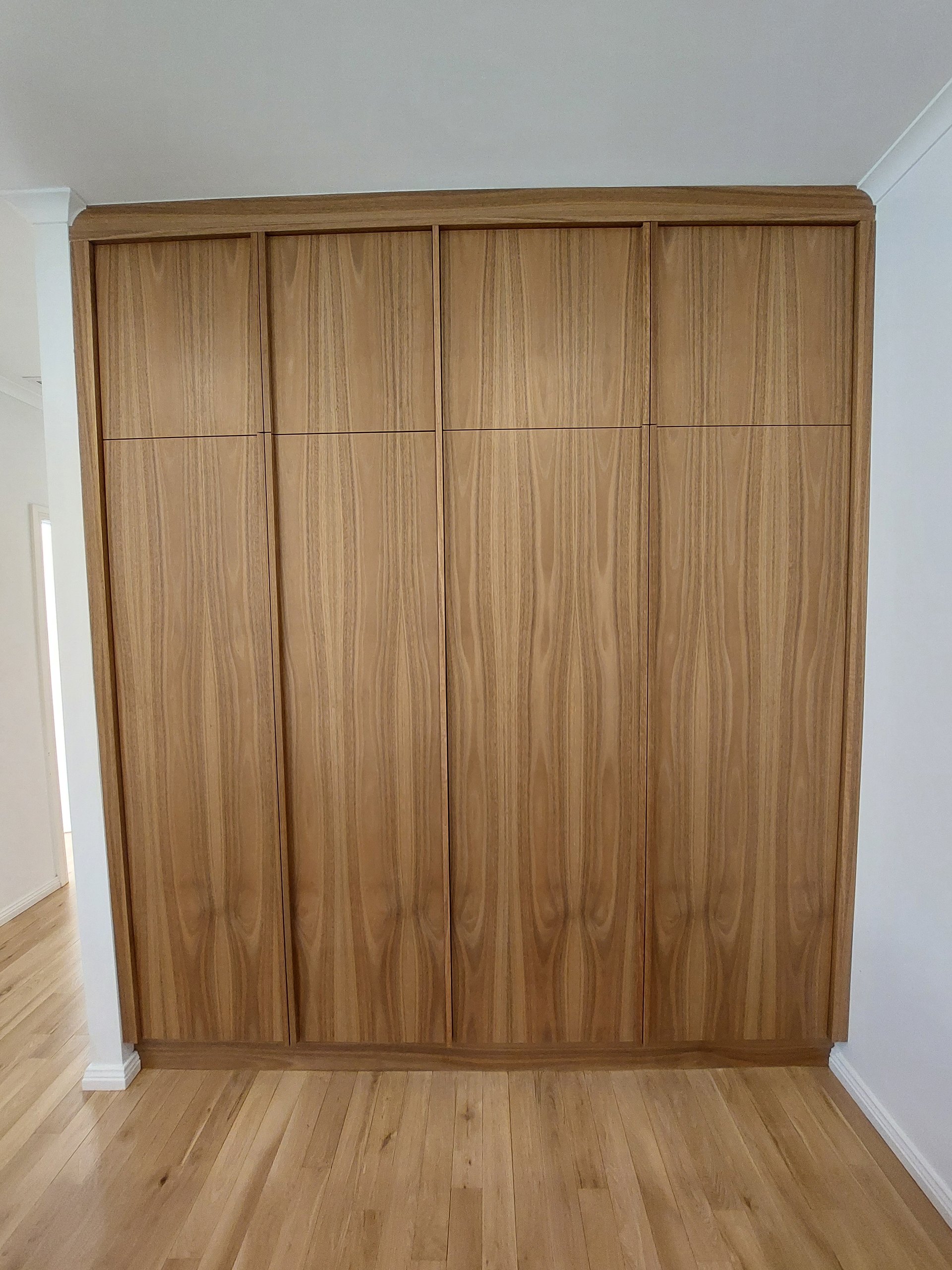 Wall of timber laundry doors closed, flush with the wall