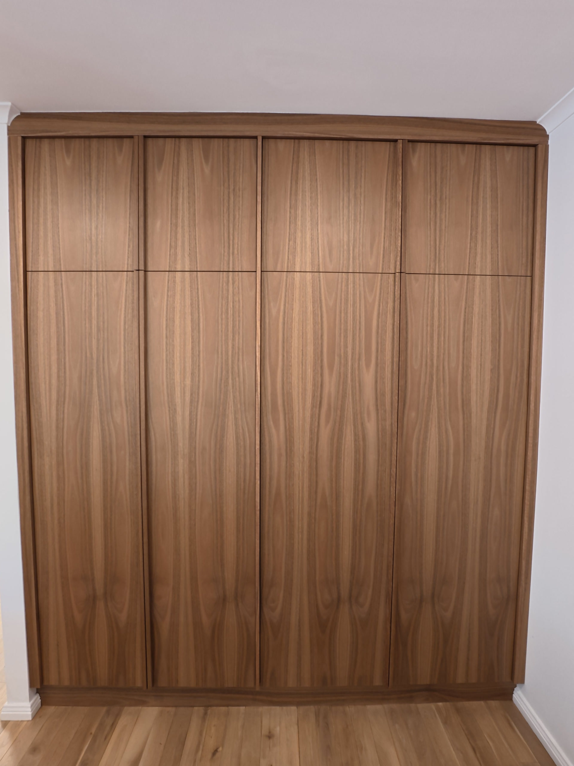 Wall of timber doors concealing the laundry, closed