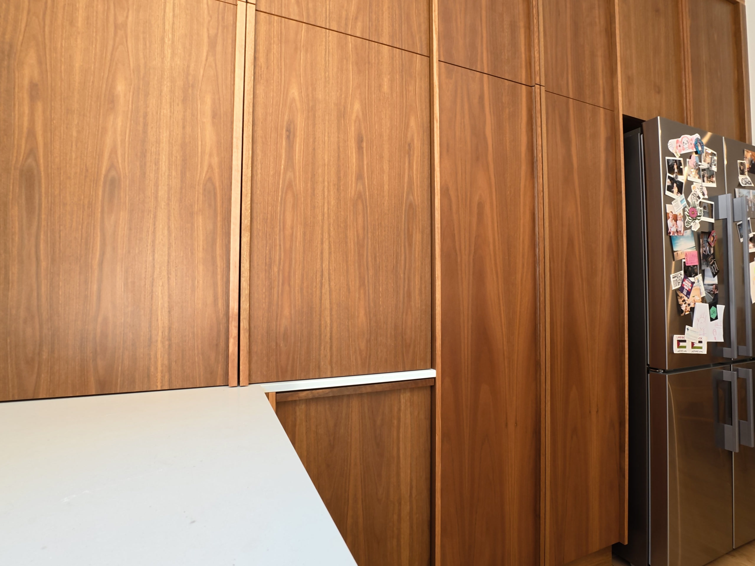 Full-height timber pantry wall beside the fridge in the Kilkenny kitchen